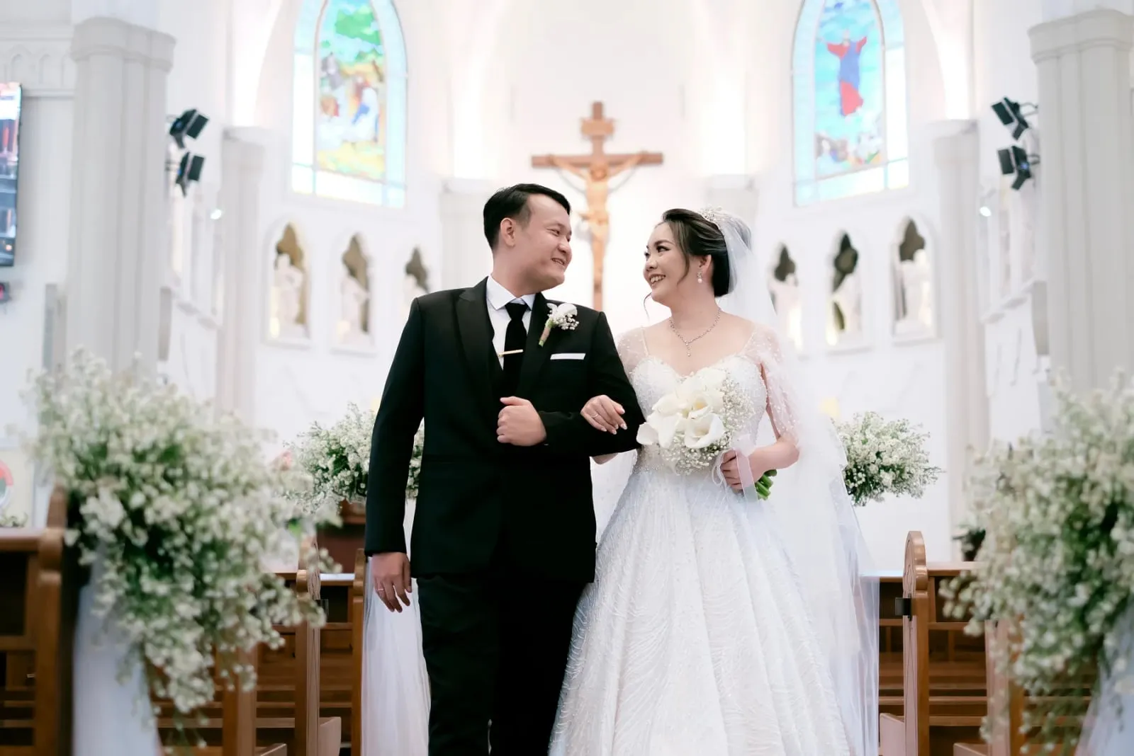 Pengantin berdiri di depan altar gereja setelah pemberkatan